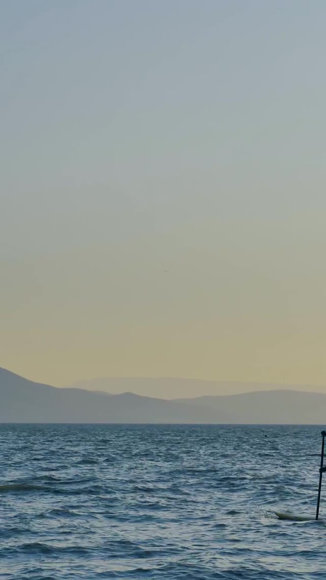 Calm Sea with Distant Mountains