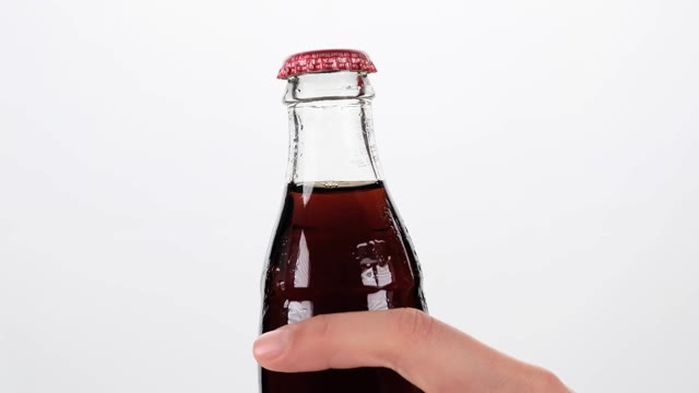 Hand Holding Soda Bottle